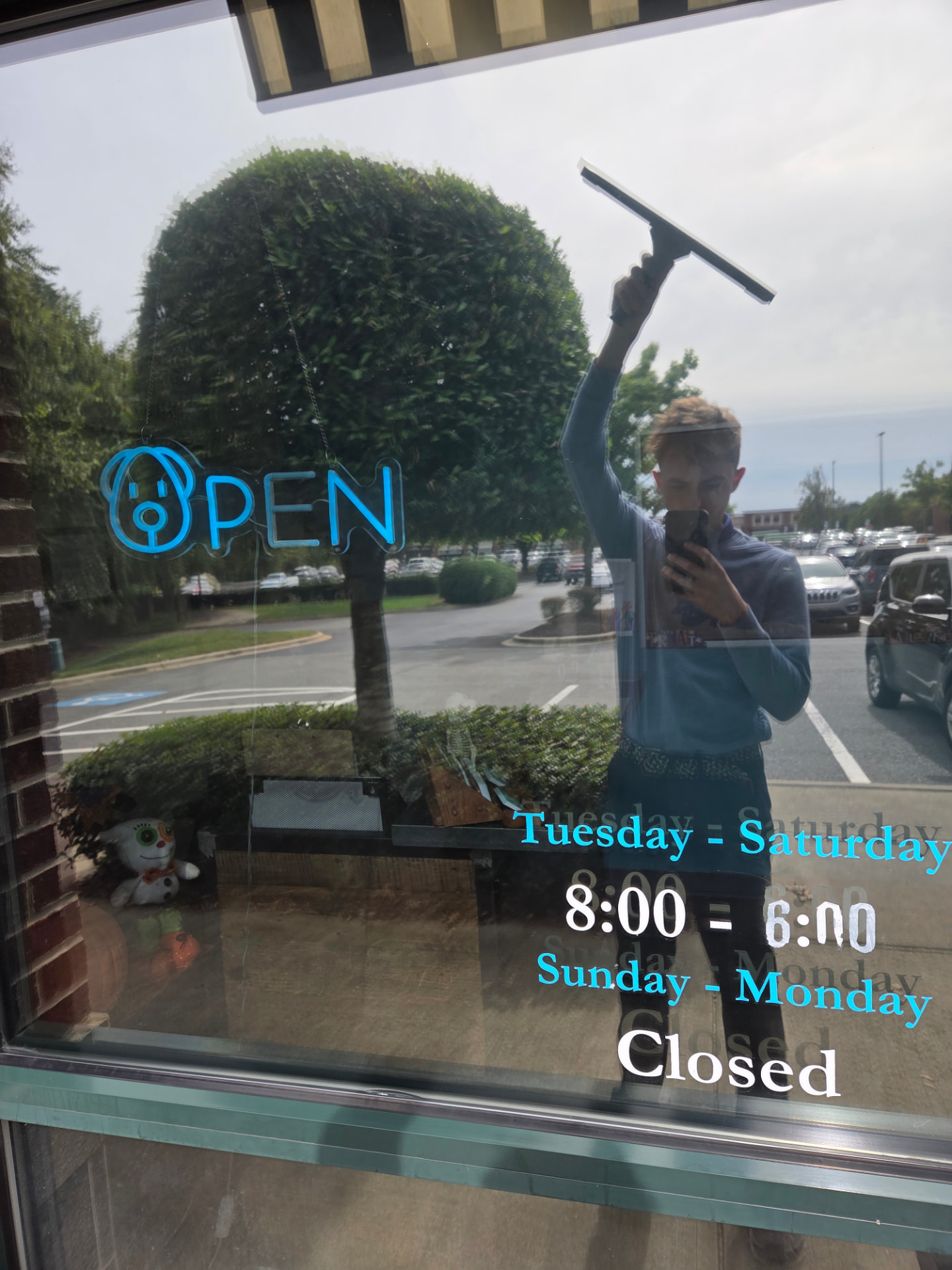 Vista squeegee cleaning storefront glass in Concord, NC